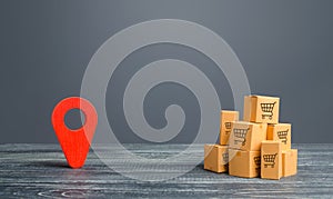 Red location pointer geolocation symbol and cardboard boxes. Distribution delivery of goods, freight transportation shipment.