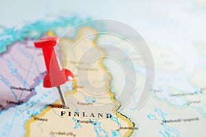 Red locator push pin in a map of Finland