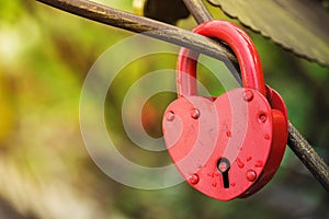 Red lock in the shape of heart as symbol of love