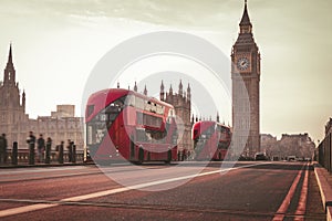 Red London Bus on the Westminster Bridge and Big Ben Tower in the background