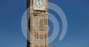 Red London buses crossing in front of Big Ben, Houses of Parliament in a blue sky, summer, London, England