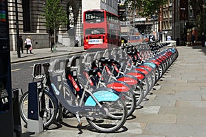 Red London double-decker bus and boris bikes