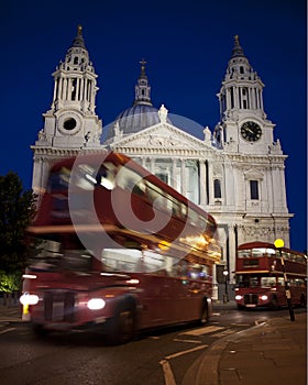 Red London Routemaster bus moving past St Pauls Cathedral Transport Movement photo