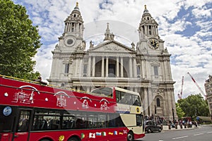 Red London sightseeing bus in front of St Pauls Cathedral, London, England, UK, May 20, 2017