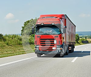 Red lorry with trailer on highway