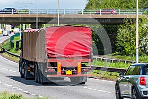 Red lorry truck on uk motorway in fast motion