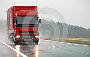 Red lorry on wet road