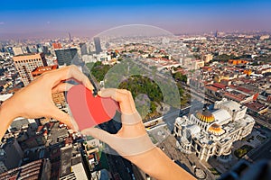 Hand hold red heart, central Alameda park, Mexico photo