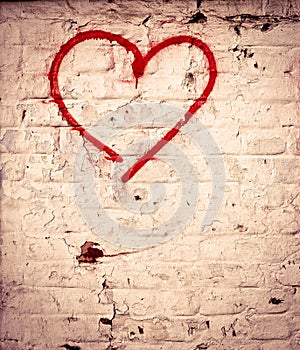 Red Love Heart hand drawn on brick wall grunge textured background