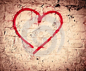 Red Love Heart hand drawn on brick wall grunge textured background