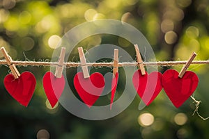 red love hearts pegged onto a clothes line outdoors