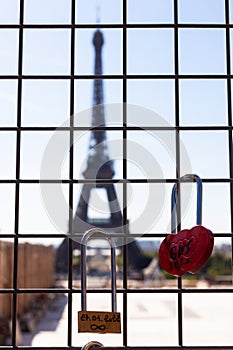 Red love lock, with two lovers' names and Eiffel Tower on background, Paris