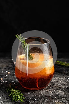 Red low alcohol drink, chilled colorful beverages on rustic black background. summer party. Alcoholic drink concept. Freeze motion