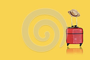 Red luggage with camera,  binoculars with hat on yellow isolated  background for activity lifestyle outdoors freedom or travel