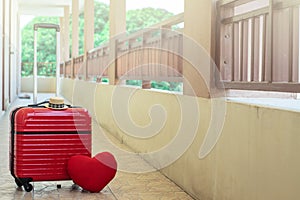 Red luggage with red heart on blurred for activity lifestyle outdoors