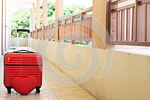 Red luggage with red heart on blurred for activity lifestyle outdoors