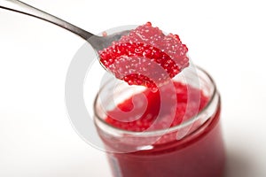 red lumpfish roe in spoon on white background