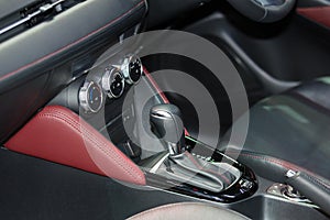 Red luxury car Interior with steering wheel, shift lever and air