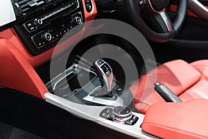 Red luxury car Interior with steering wheel, shift lever and air