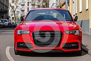 red luxury car parked on city