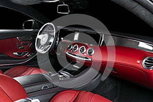 Red luxury modern car Interior with steering wheel, shift lever and dashboard. Clipping path. Detail of modern car interior. Autom