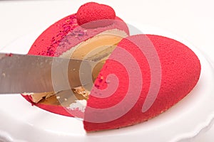 Red luxury mousse cake decorated with roses. Valentine`s Day celebration. Love
