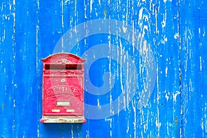 Red mail box on textured wall