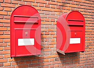 Red mail boxes on brick wall