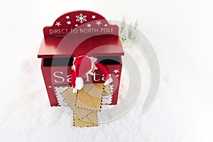 Red mailbox for Christmas mailings with letters to Santa Claus and Elf. photo