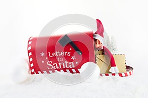 Red mailbox for Christmas mailings with letters to Santa Claus and Elf. photo