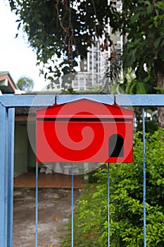 Red mailbox Hanging on the home fence