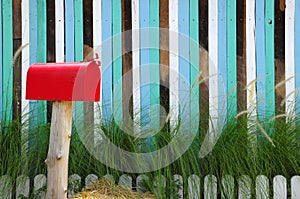 Red mailbox on a multicolored lath background