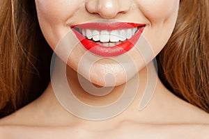 Red makeup Lips with trendy color tint lipstick. Beautiful female smile and perfect white teeth