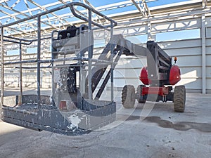 Red man lifting platform machinery at construction site