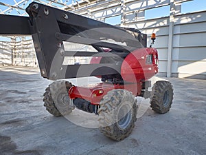 Red man lifting platform machinery at construction site