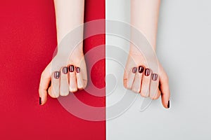 Red manicure on beautiful accurate woman`s hands.