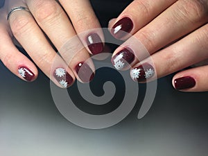 red manicure with delicate white snowflakes