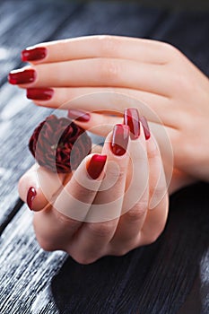 Red manicure with rose flower. spa