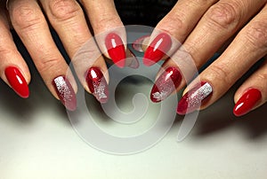 red manicure with white snowflakes on long nails