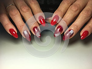 red manicure with white snowflakes on long nails