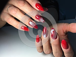 red manicure with white snowflakes on long nails