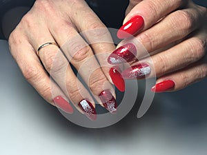 red manicure with white snowflakes on long nails