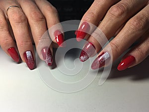 red manicure with white snowflakes on long nails