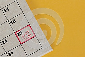 Red mark on the calendar at 25 for reminder of baby due date.