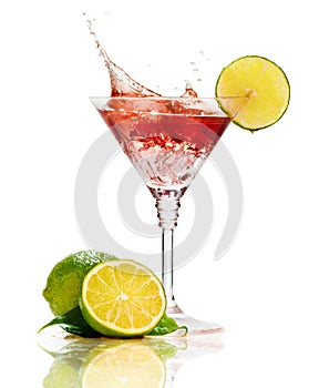 Red martini cocktail with splash and lime
