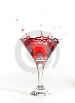 Red martini cocktail splashing