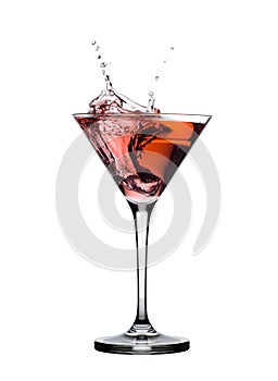 Red martini cocktail splashing in glass isolated