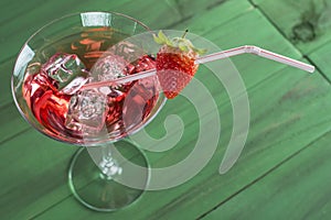 Red martini cocktail with strawberry