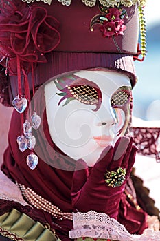 Red mask sending a kiss at Carnival of Venice