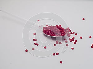 Red masterbatch granules isolated on a white background,This polymer is a coloring agent for products in the plastics industry